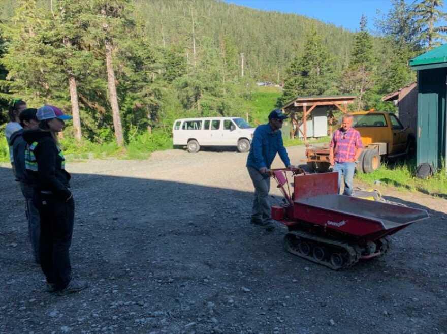 Crew Lead Brian Stoody demonstrates how to use a compactor on gravel for members of the COVID-19 Conservation Corps at Eaglecrest Ski Area on July 2, 2020. (Adelyn Baxter/KTOO)
