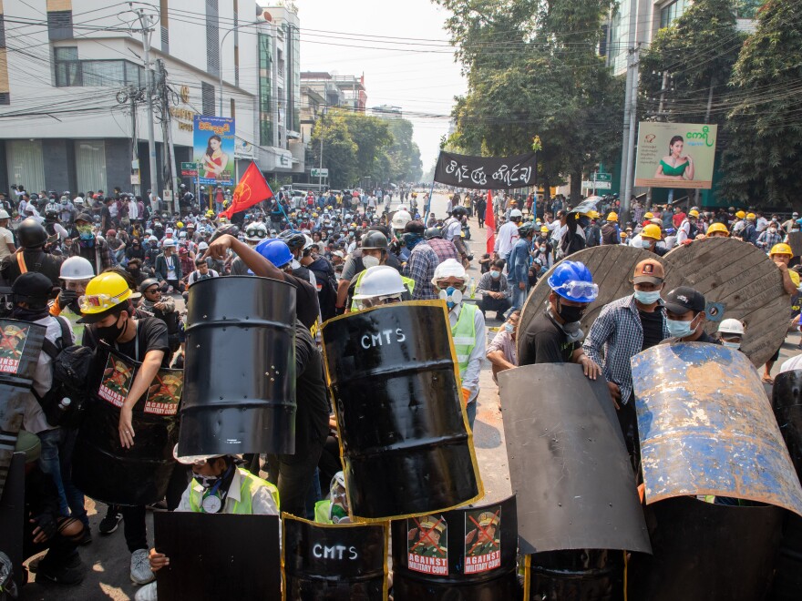 MANDALAY, MYANMAR - MARCH 3: Demonstrators take shelter and block the road during a protest against the military coup in Mandalay, Myanmar on March 3, 2021. (Photo by Stringer/Anadolu Agency via Getty Images)