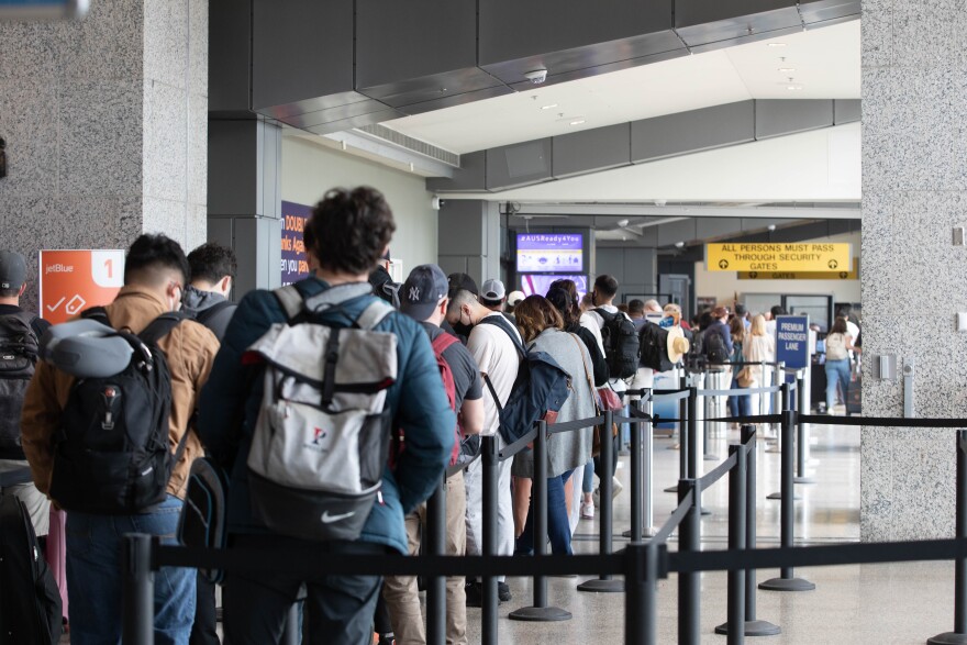 People lined up to go through TSA screening in the Barbara Jordan Terminal.