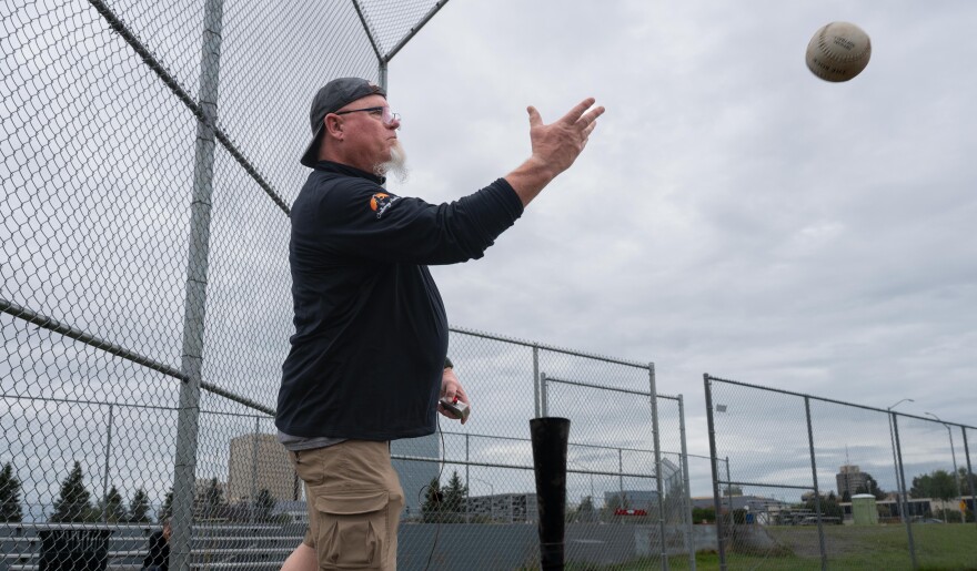 Jeff Dick, recreational therapist with Challenge Alaska, tosses a ball during a "beep ball" practice on August 9, 2025.