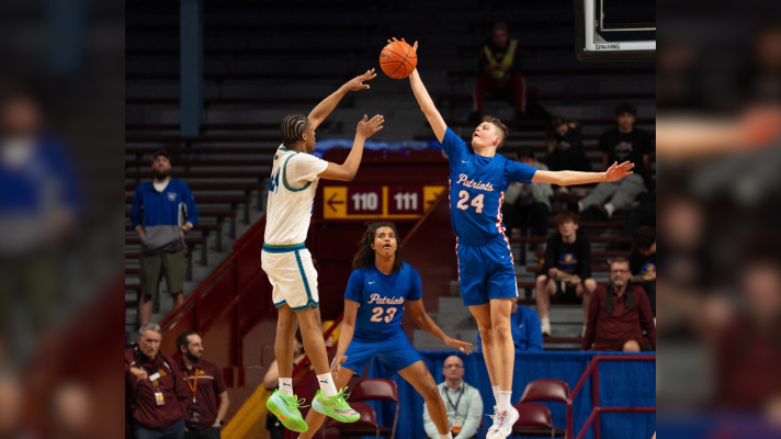 Pequot Lakes junior Sam Afagwu (23) watches sophomore Gus McKenna (24) block a shot from Blake in the first round of the boys state basketball tournament March 25, 2026, in Minneapolis.