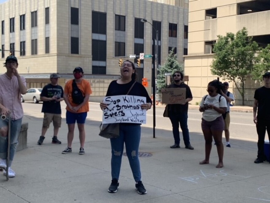 Cristhy Sotres (center) leads a small group of protestors in a chant outside the Tubbs Justice Center in downtown Akron on Friday, July 1, 2022. Protestors are calling for accountability over the death of 25-year-old Jayland Walker, who was killed by police after a car chase earlier this week.