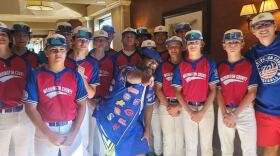 Mayor JoJo Burgess of Washington, Pa., poses with the Washington County baseball team
