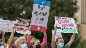 People take part in the Women's March ATX rally in reaction to the controversial ban earlier this month at the Texas State Capitol in Austin.