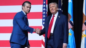President Donald Trump is greeted by Secretary of Defense Pete Hegseth before speaking to a gathering of top U.S. military commanders at Marine Corps Base Quantico, Tuesday, Sept. 30, 2025, in Quantico, Va. 