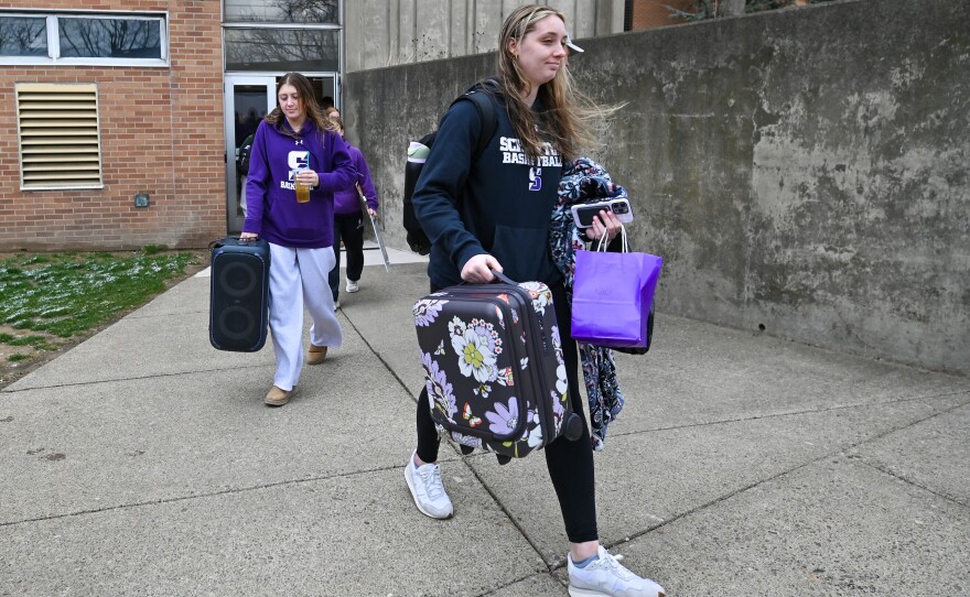 University of Scranton senior Kaci Kranson carries her bags to the bus before leaving for the Final Four in Virginia.