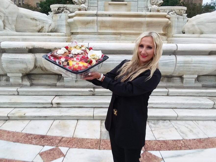 Anya Duchon, owner and president of Chrusciki Bakery, holds up a platter of samples her business will serve at the 2021 Taste of Buffalo.