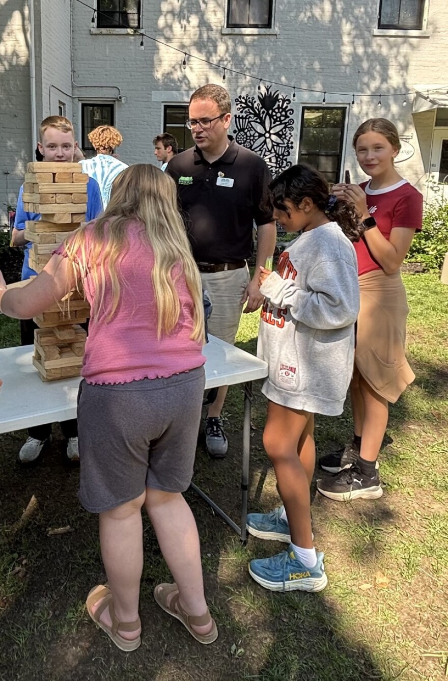 Baker Hunt Executive Director Alex Noel cheers the kids at summer camp on while they play a game.
