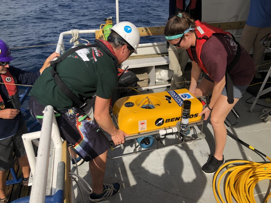 Researchers prepare to lower a drone into the waters off North Carolina's coast. 