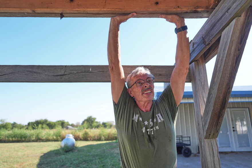 Ed Westrick adjusts a roof on a small building at his rural home near Commerce, Texas, on Sept. 18, 2026.