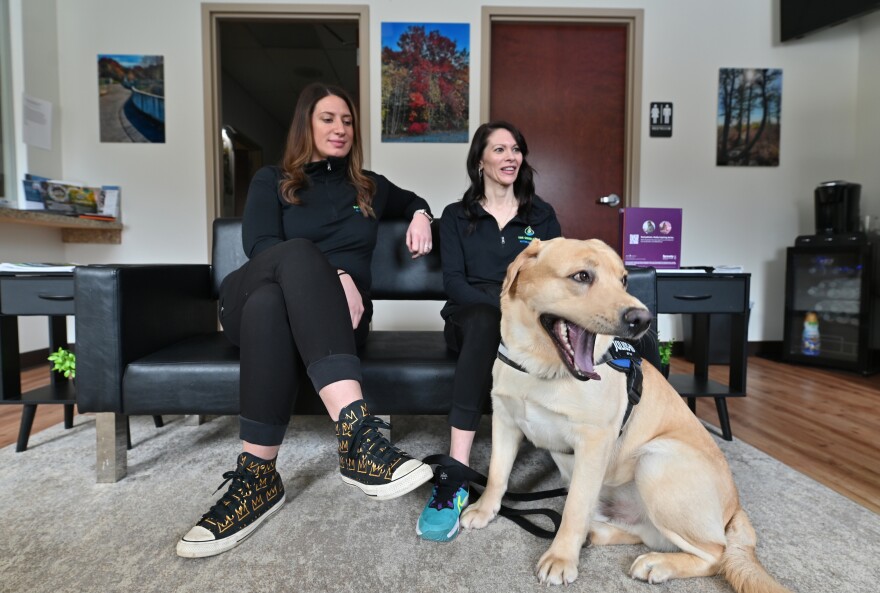 Owners Kelly Wilson and Mara Capozzi pet Peanut the office dog at The Good Drop.