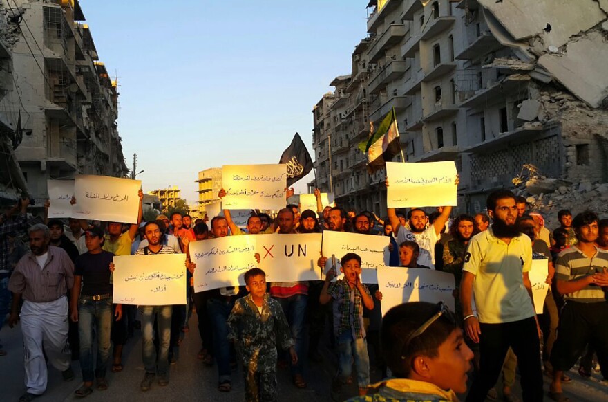 Activists in Syria's besieged city of Aleppo protest Tuesday against the United Nations for what they say is its failure to lift the siege of their rebel-held area. "Hunger better than humiliation," one banner read. "X the UN," another declared.