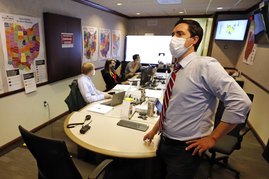 Ohio Secretary of State Frank LaRose, right, overseeing the Election Night Reporting Center in Columbus, Ohio, watches early returns in the Ohio primary election from the Election Night Command Center, Tuesday, April 28, 2020.