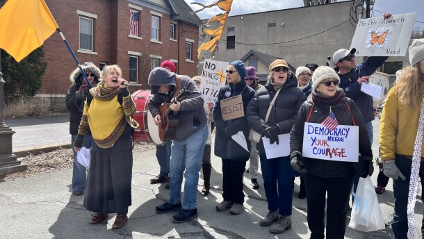 Tannis Kowalchuk, left with microphone, leads the Singing Resistance NEPA choir during a No Kings march in Honesdale.