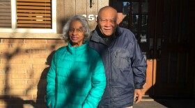 Violet and Norward Brooks in front of a house they struggled to buy due to discrimination.