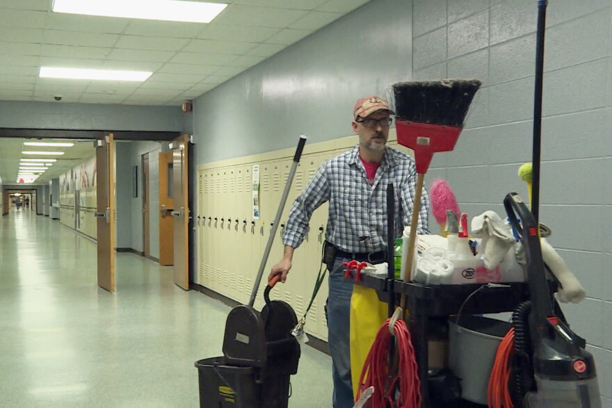 A member of Monrovia High School's custodial staff walks through a hallway during the school day.