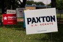 Candidate signs, including one for Republican Senate primary candidate and current Texas Attorney General Ken Paxton, line the entrance to the Royal Lane Baptist Church polling location as voters cast ballots during local and primary runoff elections, including the closely watched Texas Republican Senate runoff, Tuesday, May 26, 2026, in Dallas.
