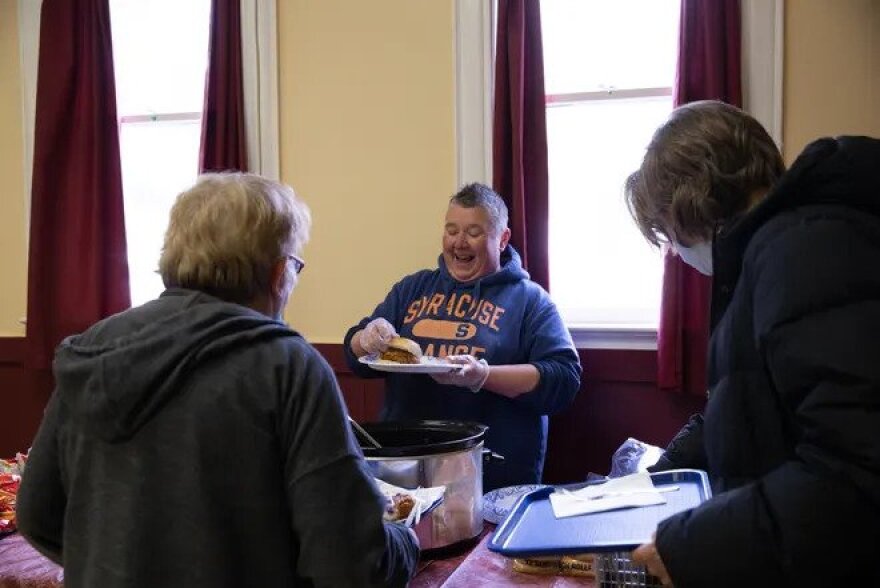 Katie Haney, a member of Rainbow Seniors ROC, prepares and serves meals for the organization’s weekly Tuesday luncheons. The menu on a Tuesday in April consisted of pulled pork sandwiches, pasta salad and a variety of snacks.