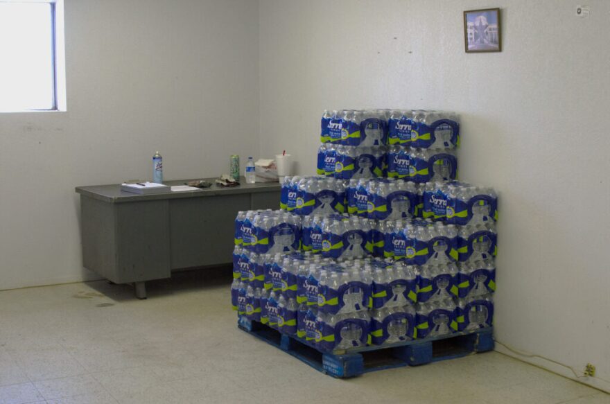 Reeves County began distributing bottled drinking water in January to Toyah residents. County employees store pallets of water bottles in town.