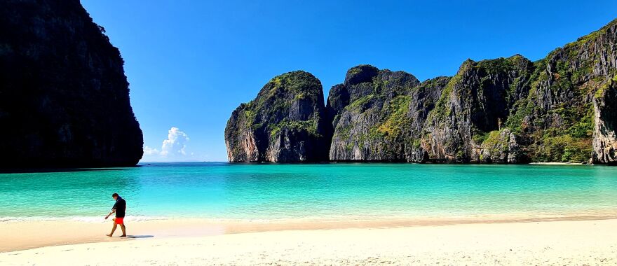 A tourist strolls along the white sand of Maya Beach in Thailand. The destination was once overrun by visitors, but thanks in part to the pandemic, its ecosystem has had time to recover.