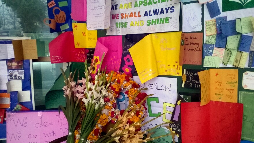 Noticeboards are festooned with pictures, cards and bouquets of flowers at the Army Public School in Peshawar.