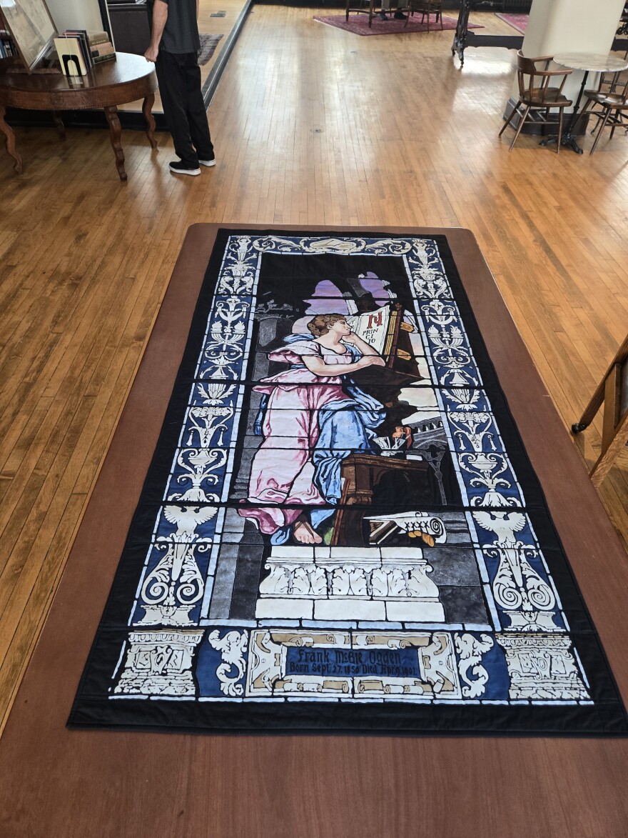 Katherine Durack made a quilt that is almost an exact copy of the Cincinnati's Mercantile Library's missing "Woman Reading Book" stained glass window. It's part of a series of quilts Durack has made commemorating moments in Ohio's Women's Suffrage movement.