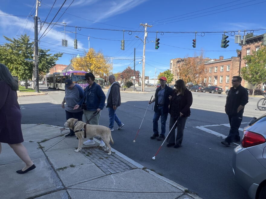 People cross Washington Avenue in Albany on Thursday, Oct. 15, 2026, during an event to recognize White Cane Awareness Day.