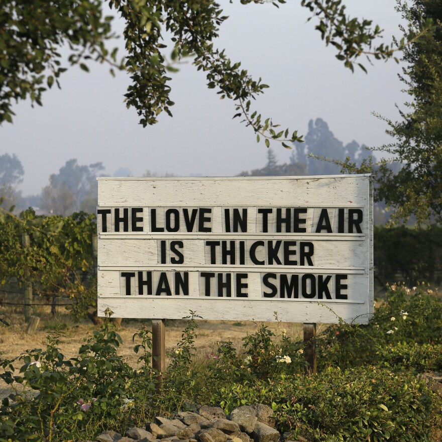 A sign in a vineyard outside the Cline Cellars winery shares a note of optimism on Monday in Sonoma, Calif.