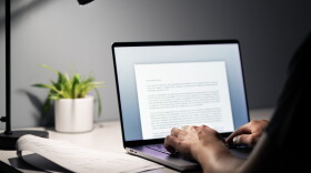 Man writing text document, essay or letter with laptop. Freelance writer, journalist or entrepreneur working late at night, overtime. Job seeker, cv resume and application. Dark home or office room.