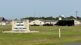 FILE - Law enforcement vehicles sit parked outside the Florida state prison in Starke, Fla., on Tuesday, July 28, 2026.