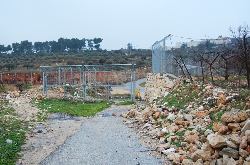 Israelis put up a small fence at the edge of the Palestinian village of Wadi Nis more than a decade ago to stop Palestinians from driving into the settlement of Efrat.