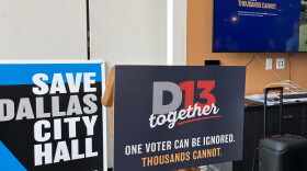 Signs for the D13 Together Coalition and Save Dallas City Hall during the D13 Together press conference August 4, 2026.