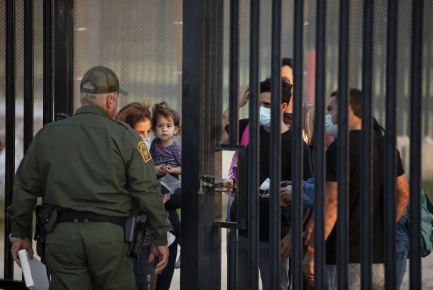 Migrants wait to turn themselves over to National Guard and Customs and Border Protection officials in Del Rio. 