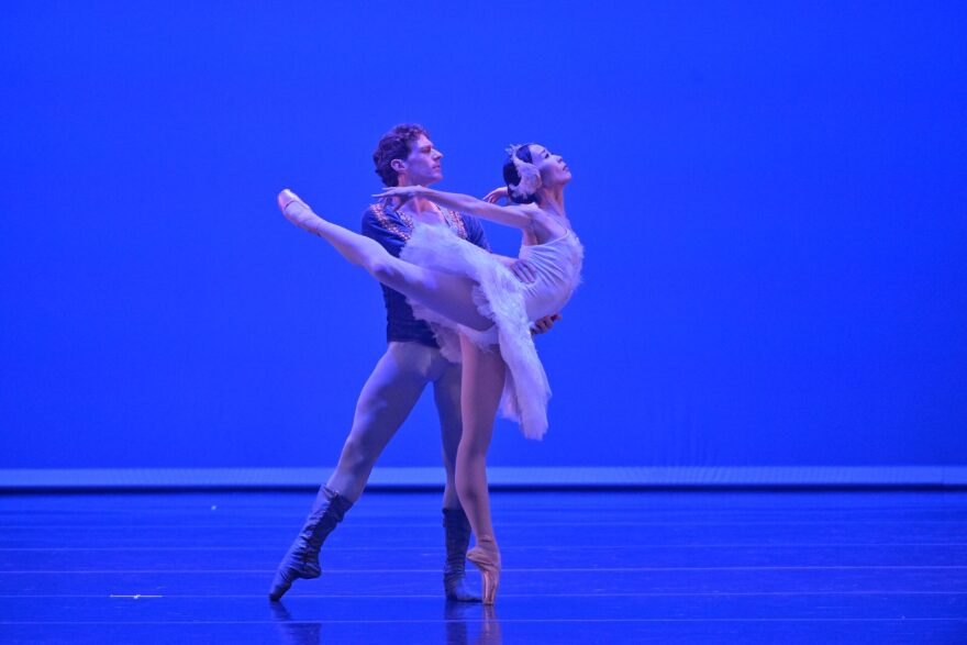 Male and female principal dancers perform on stage