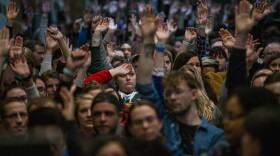 Caucus participant at Central Campus High School raise their hands to be counted. (Jesse Costa/WBUR)