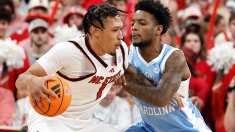 FILE - North Carolina State's Darrion Williams (1) tries to drive the ball around North Carolina's Jaydon Young (4) during the second half of an NCAA college basketball game in Raleigh, N.C., Feb. 17, 2026.