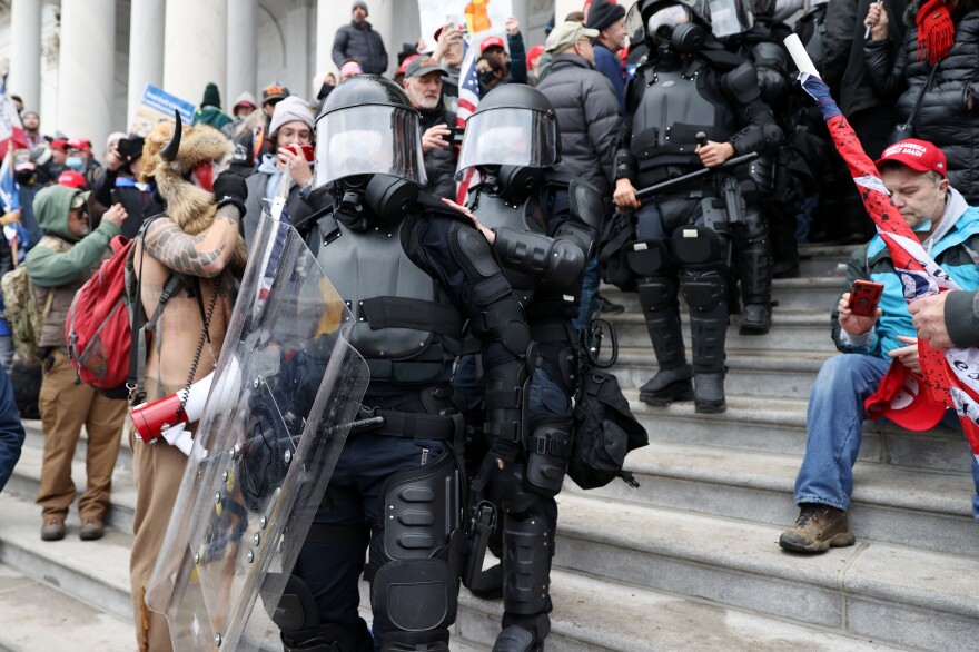 U.S. Capitol police officers make their way through pro-Trump extremists who stormed the Capitol building on Wednesday.