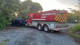 Pictured: Police and fire respond to an incident where two bodies were found in burning vehicle.