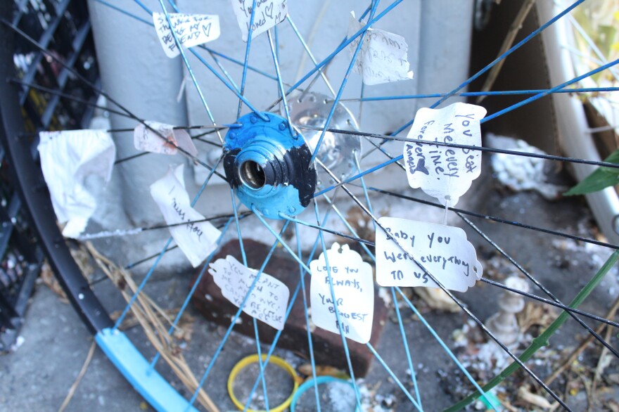 A memorial site in Manhattan, where Robyn Hightman, a bike messenger, was hit and killed by a truck this summer. People have tucked messages of support in the spokes of a bike wheel.