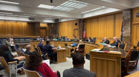 Peter Robins-Brown and Richard Davis, center, testified Thursday in opposition to a bill to stop reporting the family income of TOPS recipients.