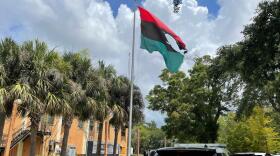 In this photo provided by Burning Spear Media, LLC, a damaged Pan-African flag flies outside the headquarters of the Uhuru Movement, a Black international socialist group based in St. Petersburg, Fla., Saturday, July 2, 2022. Earlier in the day, person using a flamethrower set fire to the flag.