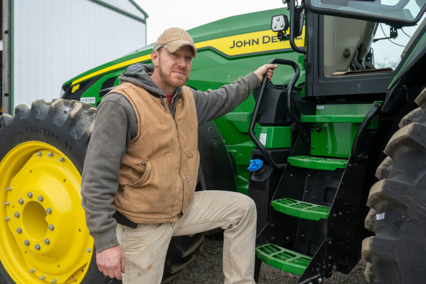 Jake Lieb with his John Deere equipment on Monday, March 18, 2024, at his farm near Monticello, Ill.