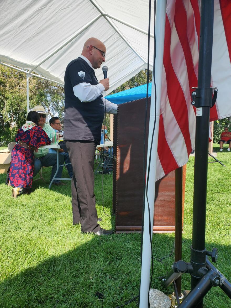 white man speaking at podium