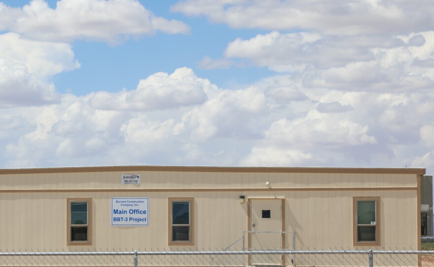 A Barnard Construction sign is pictured on a mobile building at a budding “man camp” housing facility for border wall workers south of Van Horn, Texas on June 4, 2026.