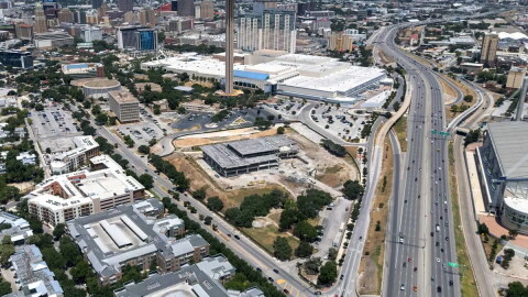 An aerial image shows downtown San Antonio, the Hemisfair area, I-37 and parts of the Alamodome and East Side. The Institute of Texan Cultures, shown in the foreground, was undergoing demolition when this image was taken in 2025.