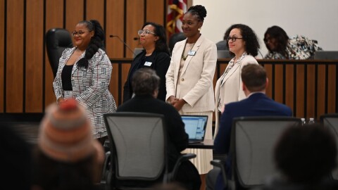 School board members vote on important issues affecting their school districts, including the hiring of a superintendent, and the district budget. Pictured above from left to right are Ashley Thomas, Indianapolis Public Schools commissioner for District 1; Deandra Thompson, IPS commissioner at large; Allissa Impink, IPS commissioner for District 4; and former commissioner Gayle Cosby.
