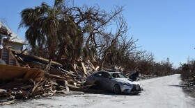 An abandoned Lexus sits in the middle of the road