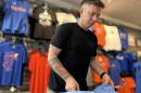 Alma Mater Custom Apparel owner Brian Meade folds Gators polos ahead of Labor Day weekend. He’s increasing the store’s stock and extending the hours of operation to prepare for more business. (Jeffrey Serber/WUFT News)
