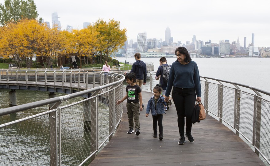 Sabrina Castillo walks with her children Lorenzo, 5, and Camila, 3, in Hoboken, N.J. "If one parent has to be home, it's probably going to be — in our culture — it's going to be ... the mother," Castillo said.