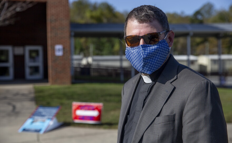 Rev. Greg Brown of Holy Comforter Episcopal Church in Charlotte volunteers with Lawyers and Collars as a vote protector at Tuckaseegee Elementary.